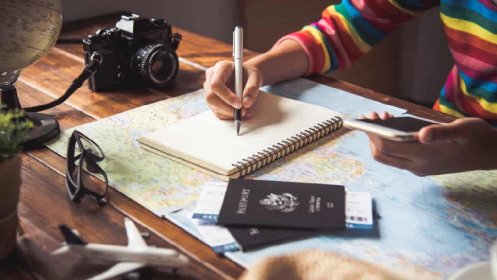 Hand holding checklist for planning and preparations in Another country